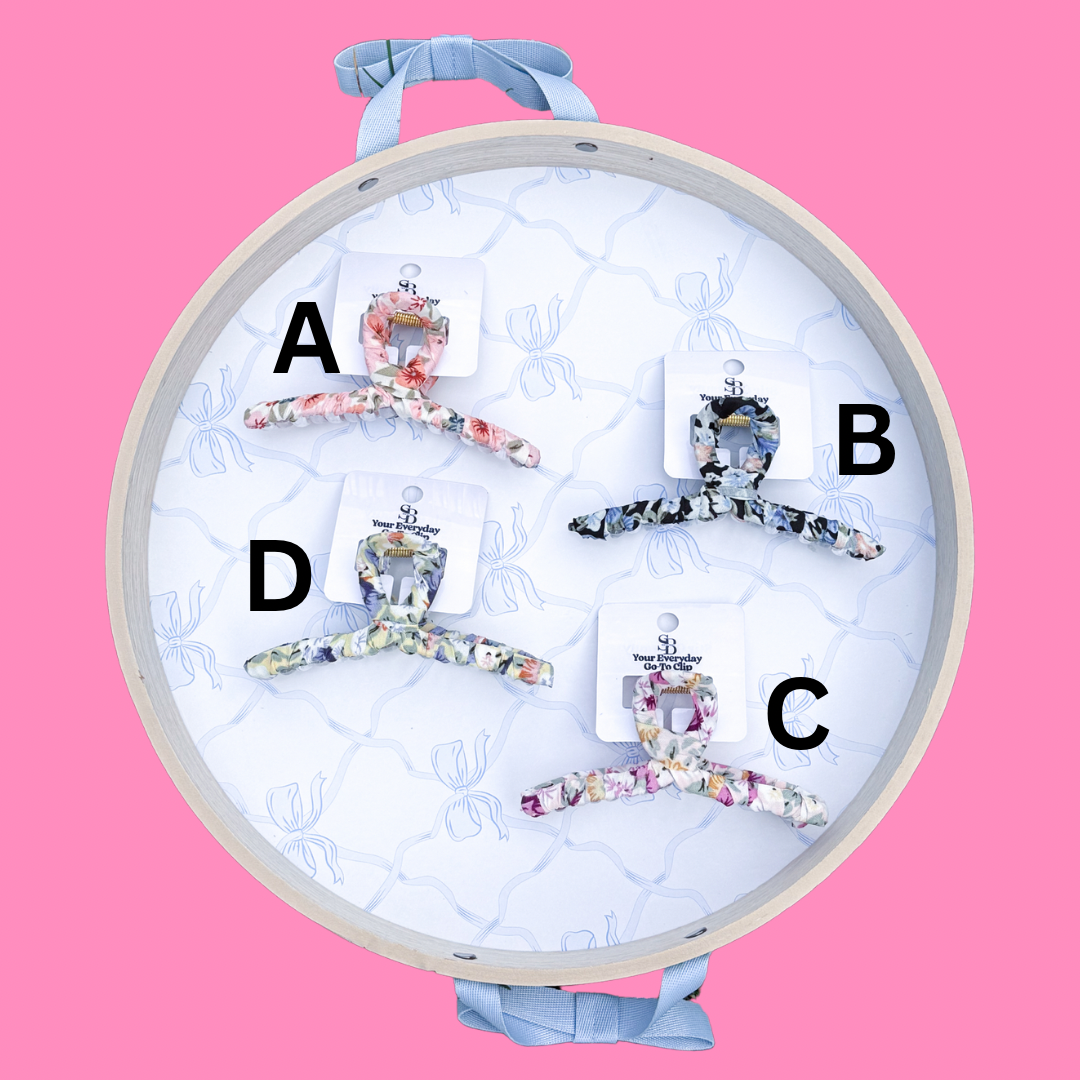 Floral claw hair clips by Your Everyday Go-To Clip, displayed on a patterned tray with ribbons.