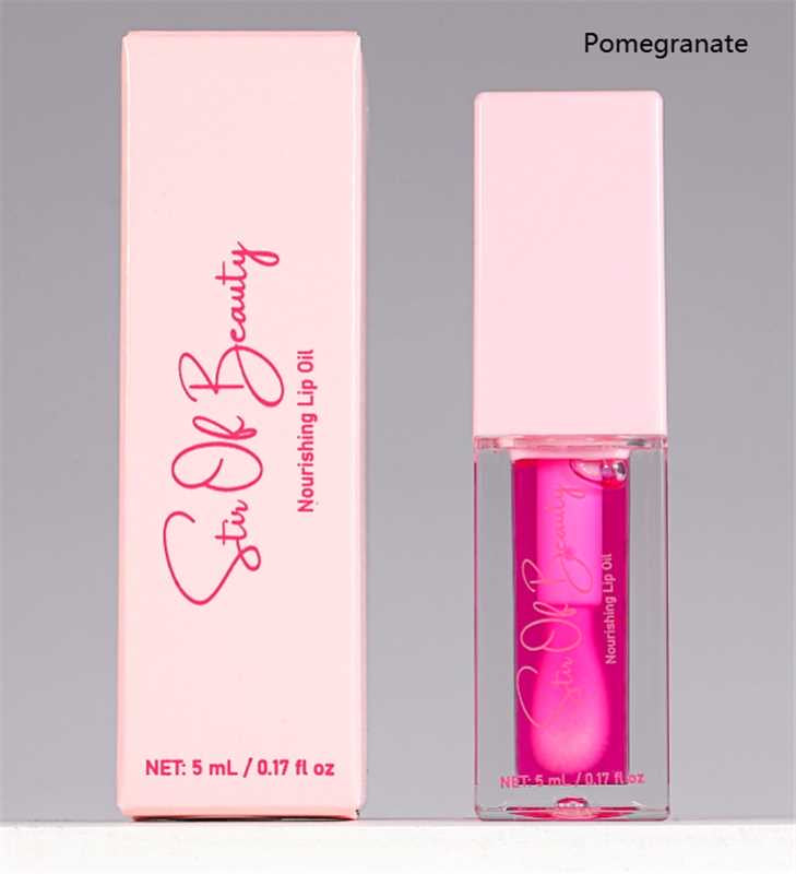 Pink lip oil with packaging labeled 'Stir of Beauty' on a gray background