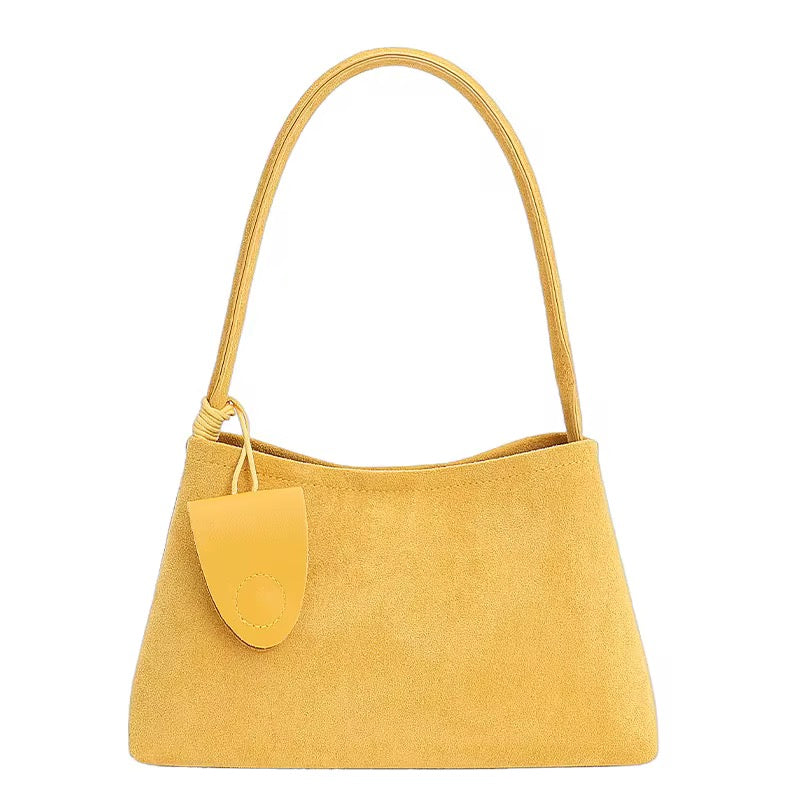 Yellow suede baguette shoulder bag with key fob.
