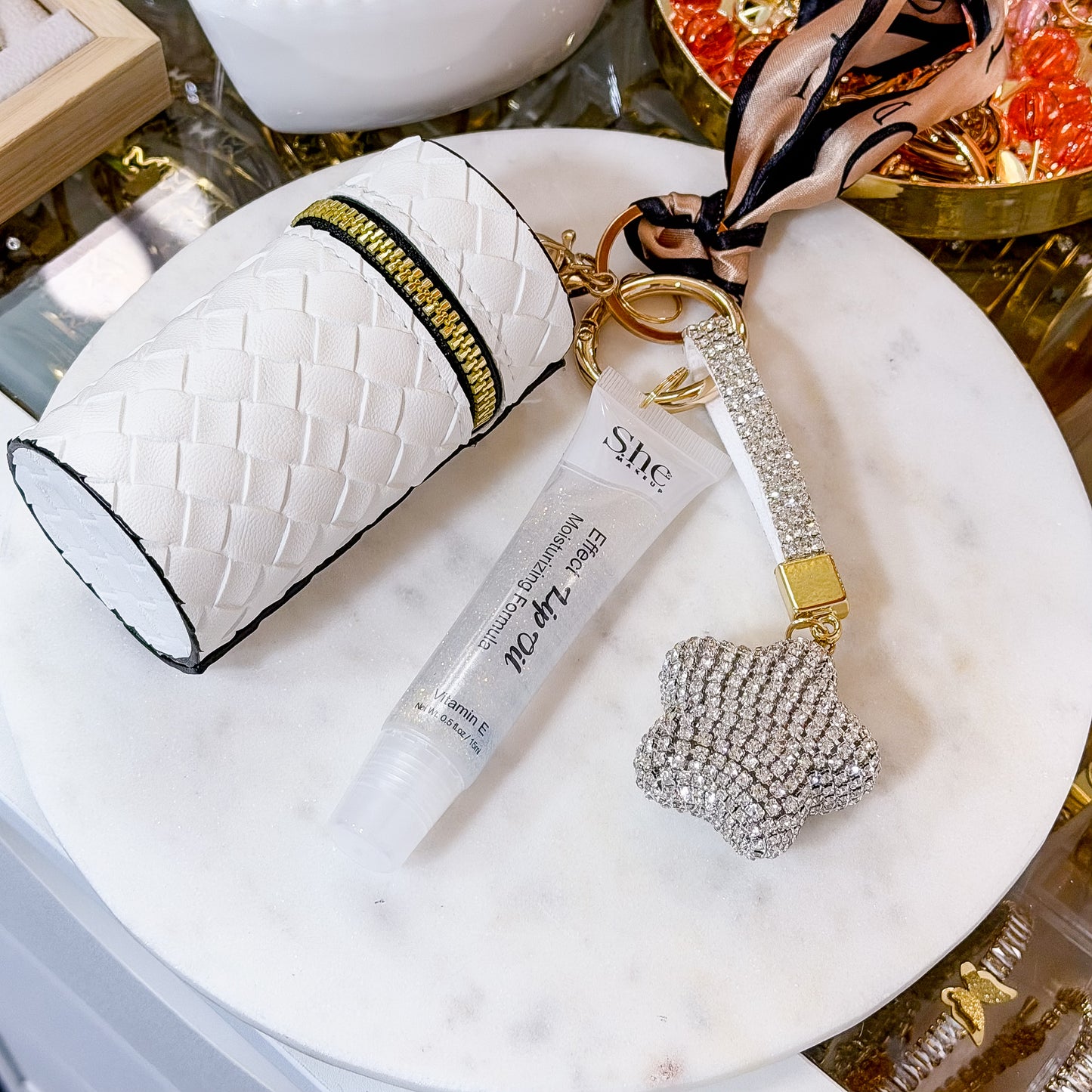 White textured coin purse combo set with matching coin pouch, clear lip gloss tube, and star-shaped rhinestone keychain displayed on a white plate.