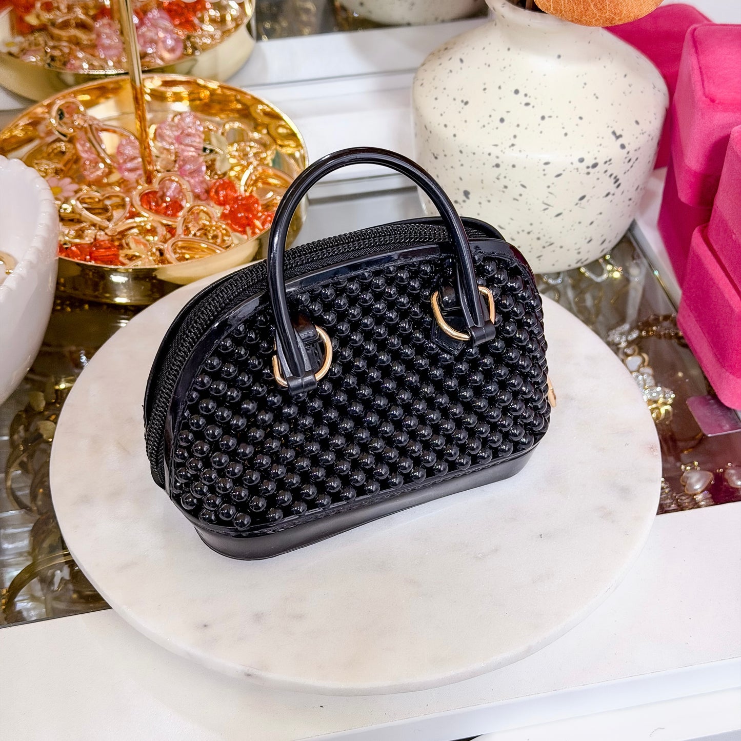 Mini black beaded dome chain bag with gold-tone hardware and a domed shape.