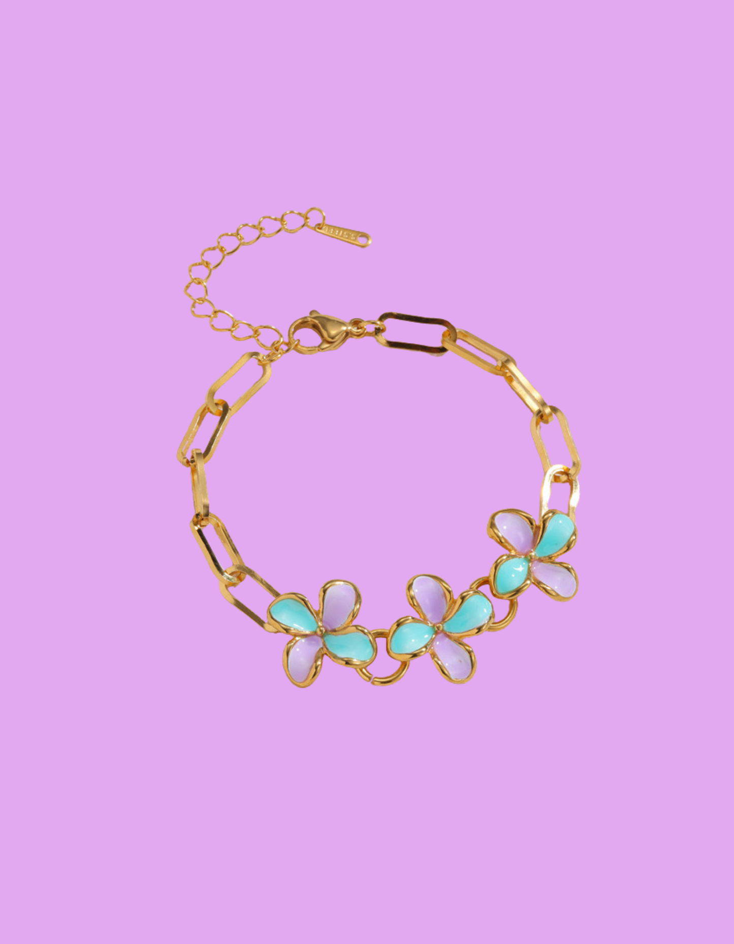 Gold-tone paperclip chain bracelet with three pastel purple and teal camellia flowers and adjustable extender.
