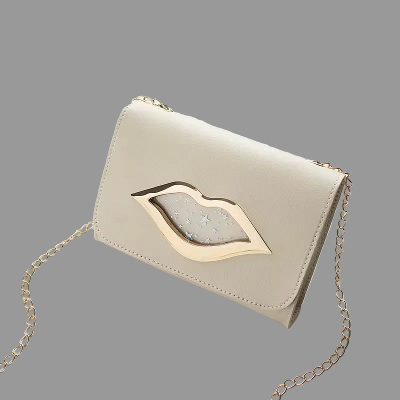Cream clutch-style handbag with silver chain strap and lip-shaped metal accent, displayed on a Grey background.