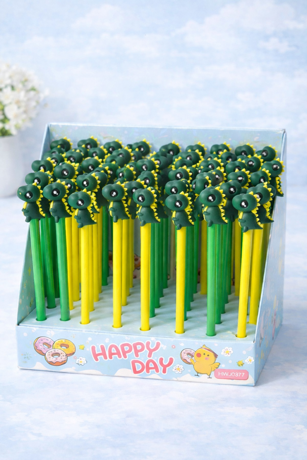 Novelty dinosaur pens with green and yellow barrels, in a display box.