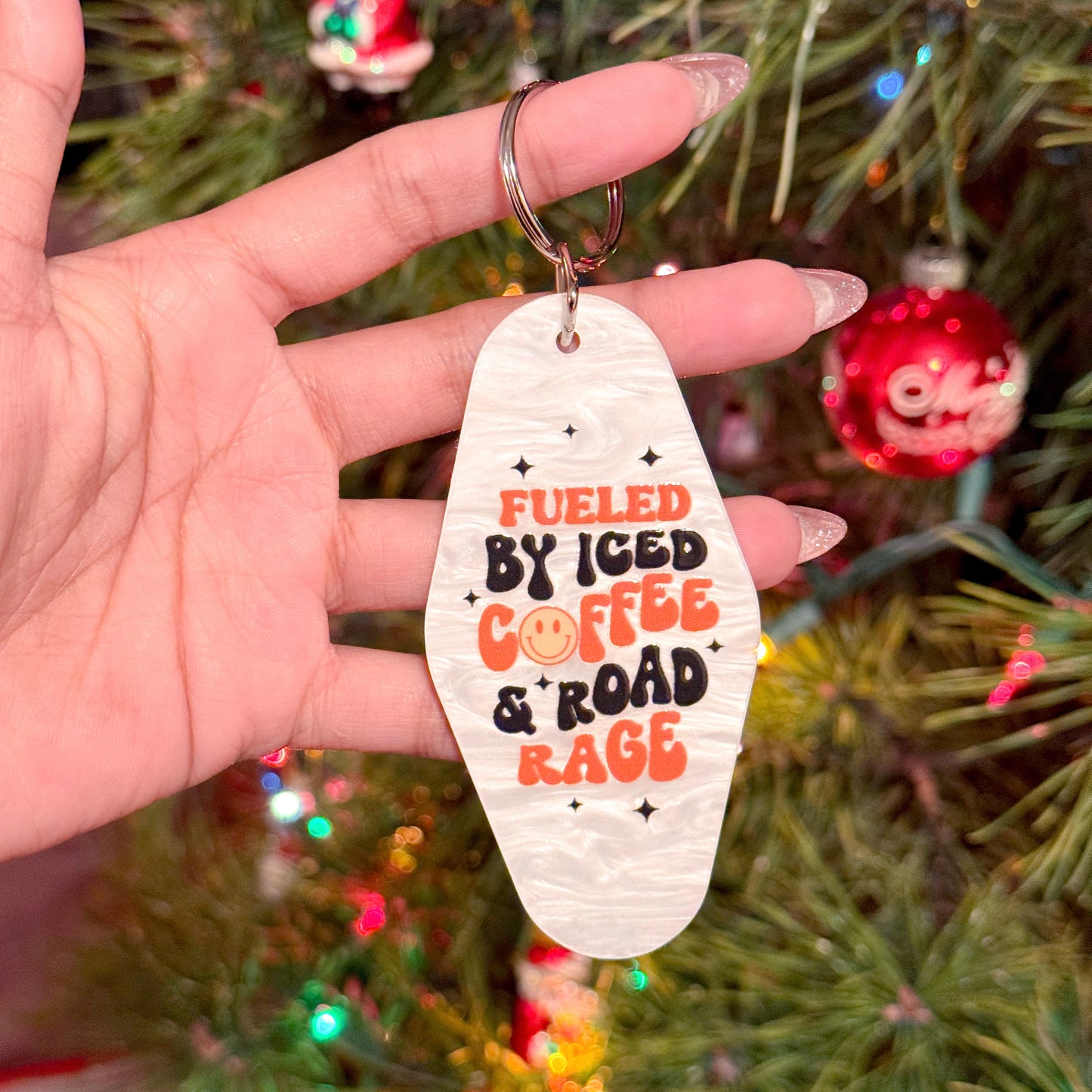 Motel keychain from 15 Styles with a "fueled by iced coffee and road rage" graphic.
