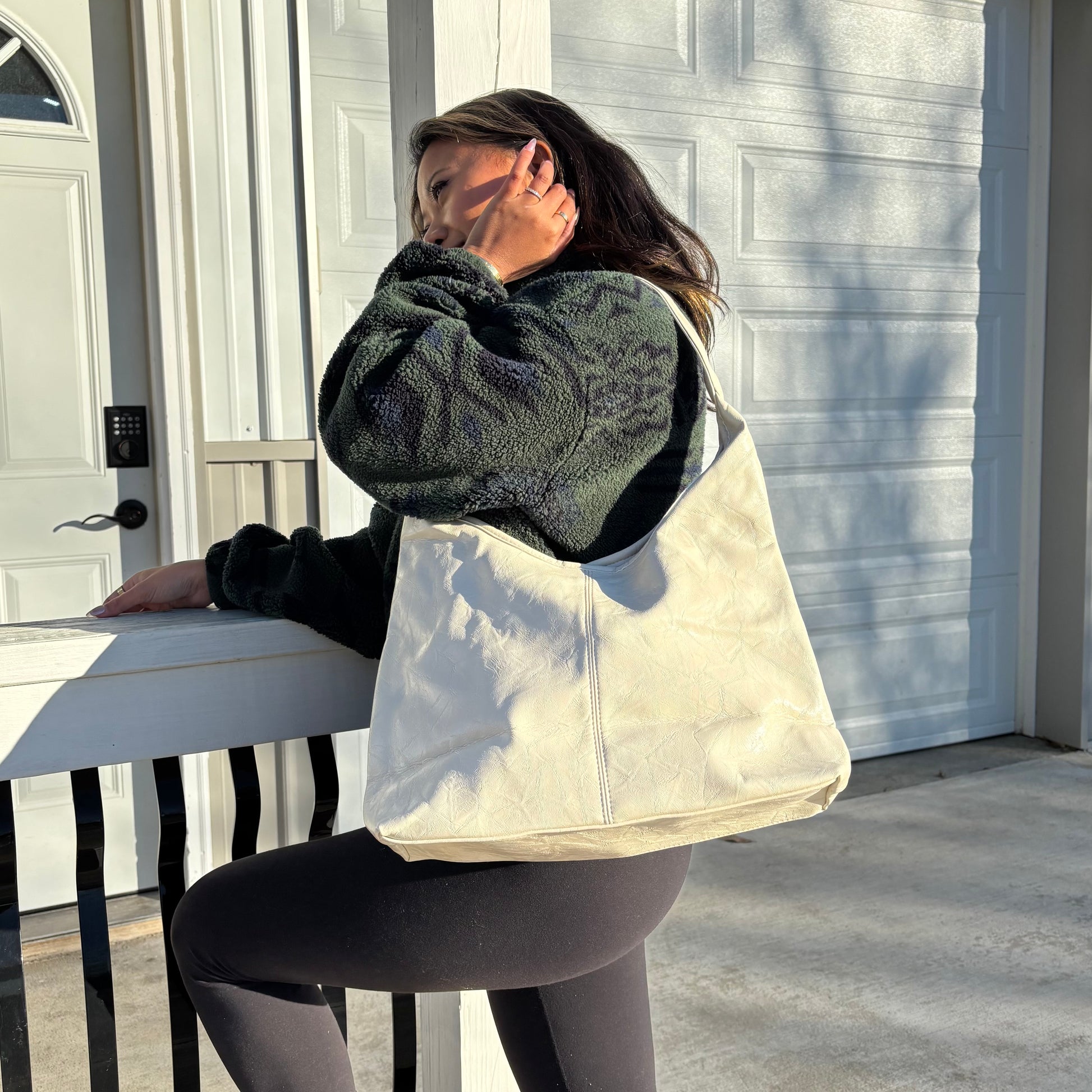 Ivory leather tote bag by The Downtown Tote Bag, with a visible seam and a textured finish.