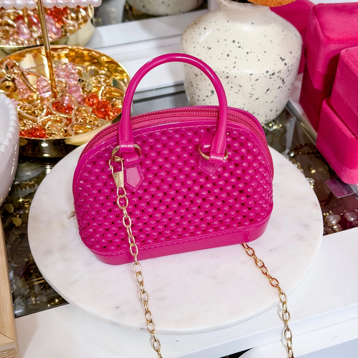 Hot pink beaded mini dome bag with chain, featuring a round top handle.