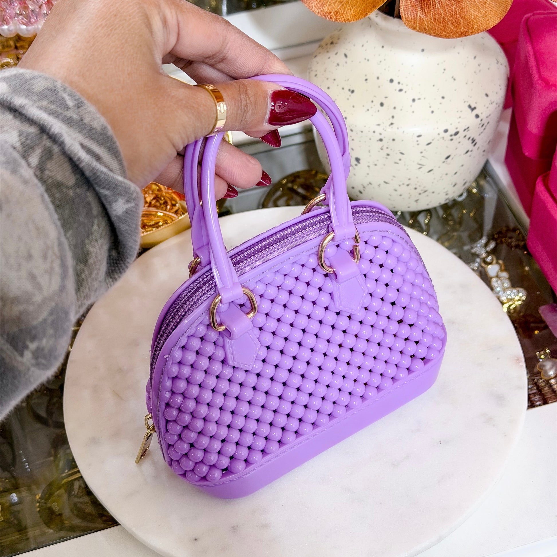 Lilac mini beaded dome chain bag with gold-tone hardware.