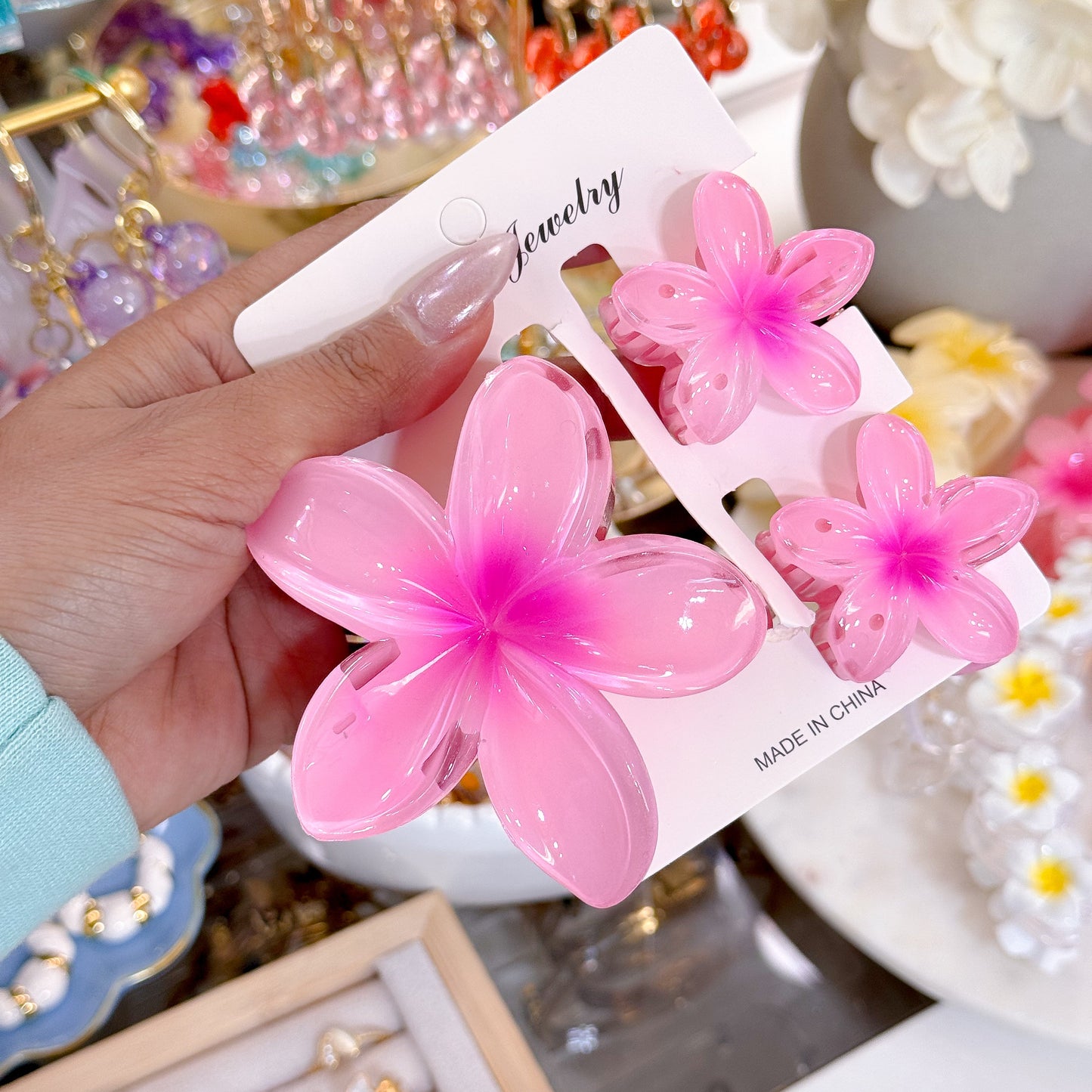 Pink flower hair clip set with the words 'Jewelry' and 'Made in China' printed on the product card.