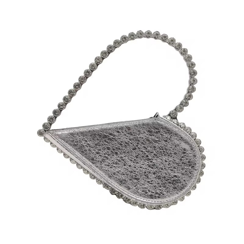 Silver handbag with jeweled handle and jeweled edges, with a crackled surface.