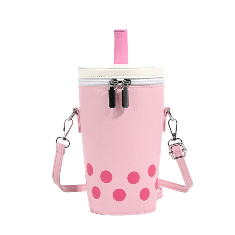 Pink boba tea crossbody bag featuring a white top, pink straw, double zippers, and pink polka dots.