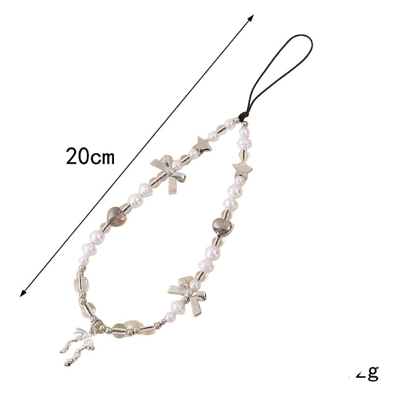 Coquette theme phone charm with white pearls, clear beads, silver bows, hearts, and stars, measuring 20cm long.