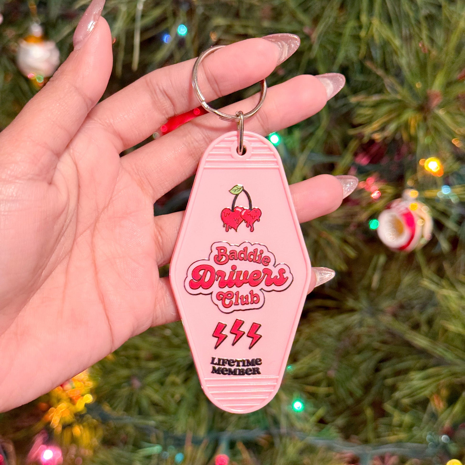 Pink motel keychain with "Baddie Drivers Club" by Shop Lavender Rain, featuring cherries, lightning bolts and a "lifetime member" inscription.