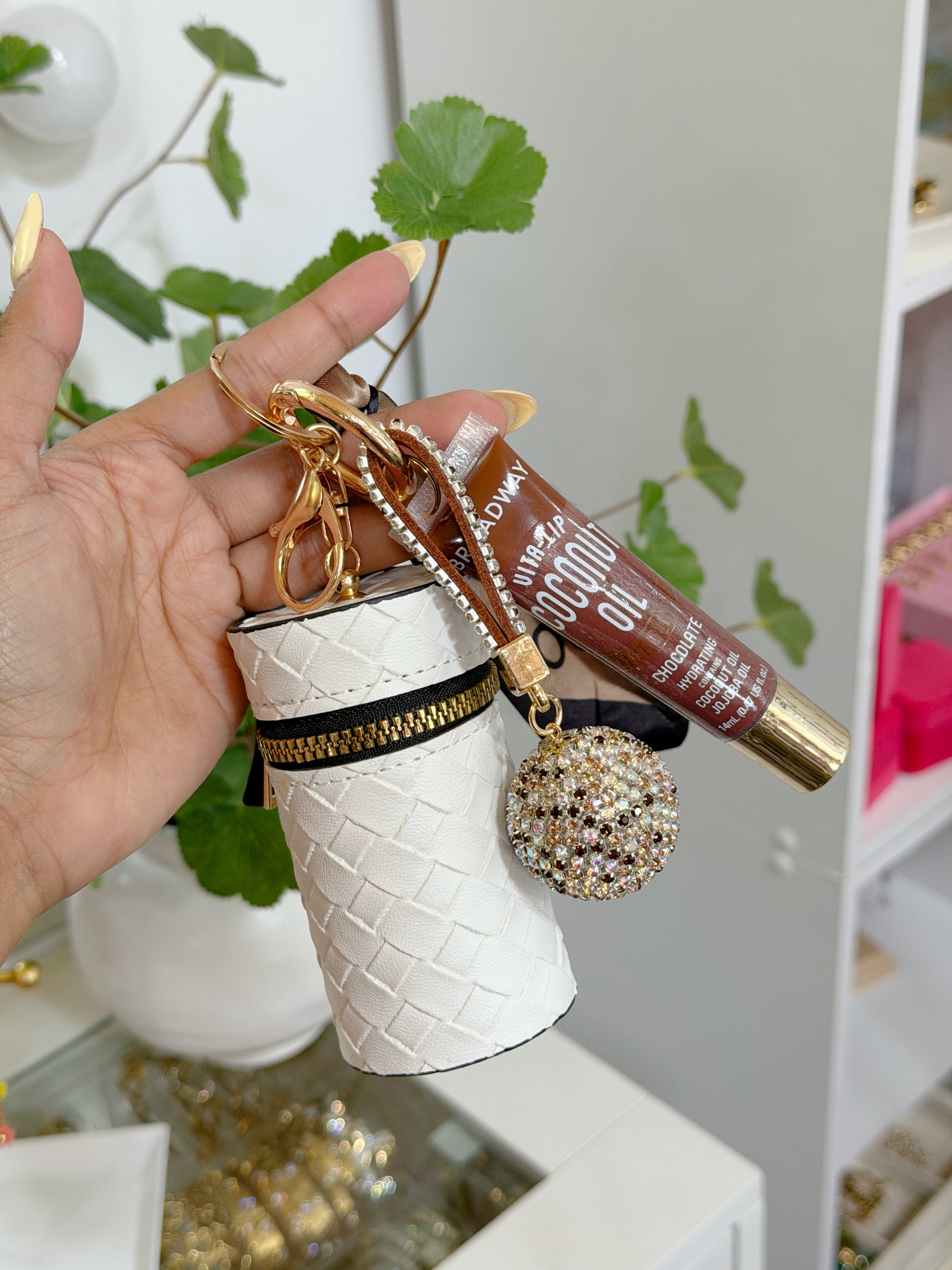 White woven coin purse combo set with black and gold zipper, brown lip gloss, and multi-colored sparkly charm.