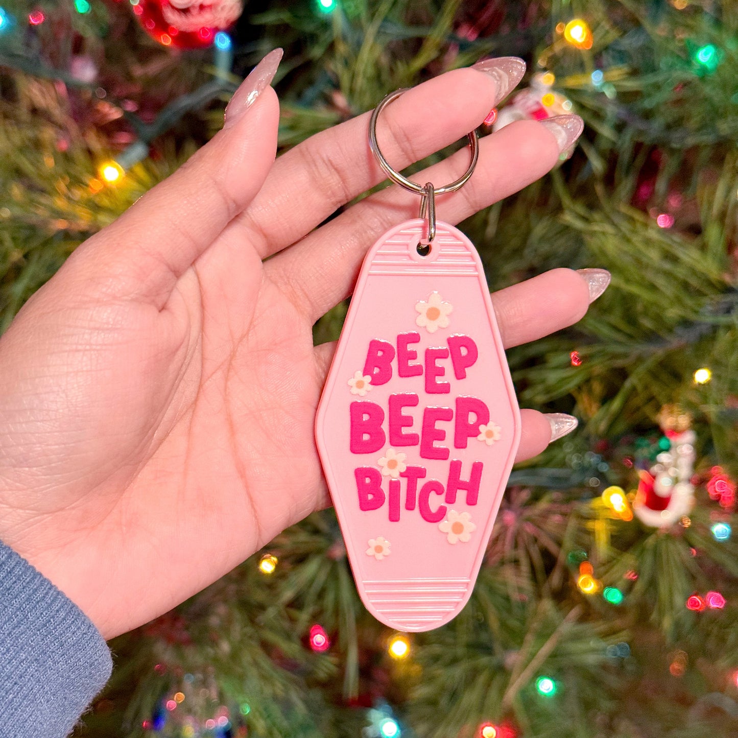 Pink motel keychain by Sweet Peas and Sassafras, with "Beep Beep Bitch" text and flower accents.
