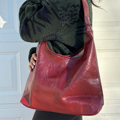Red leather hobo bag from The Downtown Tote Bag, styled with a dark green fleece jacket.