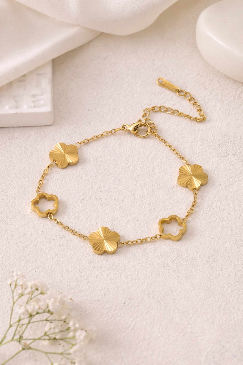 Gold Hallow Clover Link Bracelet by S-STEEL featuring alternating hollow and ridged clover links.