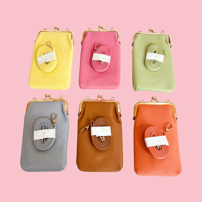 Six slim phone crossbody bags displayed on a pink background in yellow, pink, light green, gray, brown, and orange, each with a gold clasp frame and a matching detachable strap placed on the front.