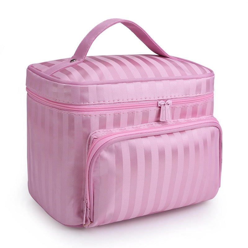 Pink vertical striped makeup bag by Bella with a top handle and a zippered front pocket.