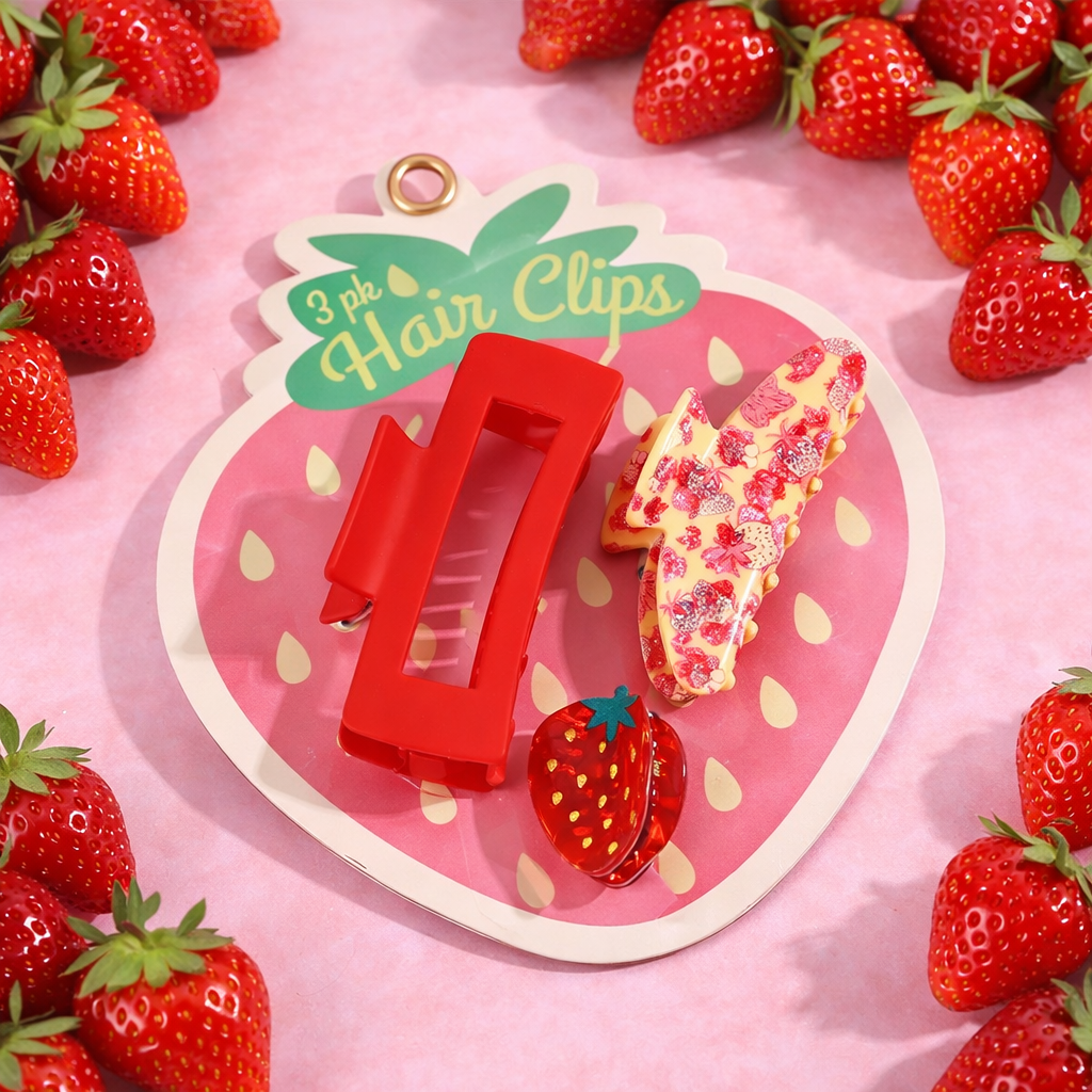 Strawberry hair claw clips set in assorted red and pink styles displayed on a strawberry-themed backing card.