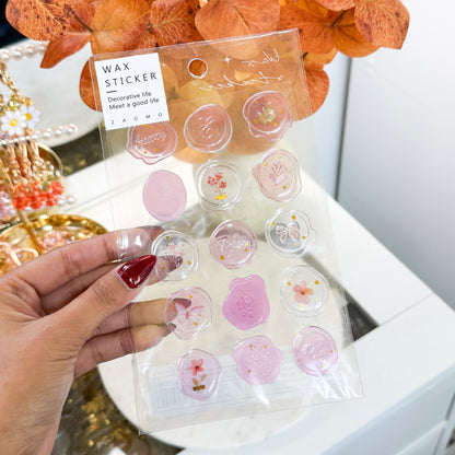 Wax seal stickers by ZAOMG, a sheet of pink and clear stickers with floral and letter designs.