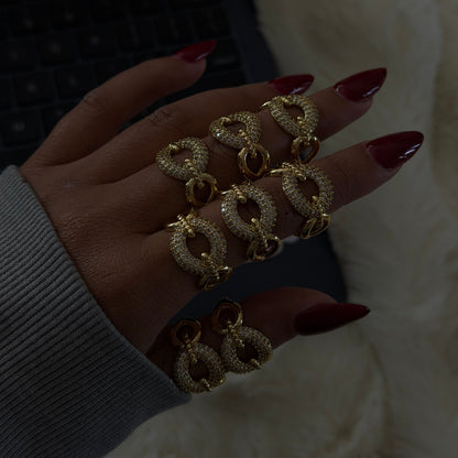 Gold adjustable statement ring featuring a pavé-set circular design, shown stacked and worn on hand.