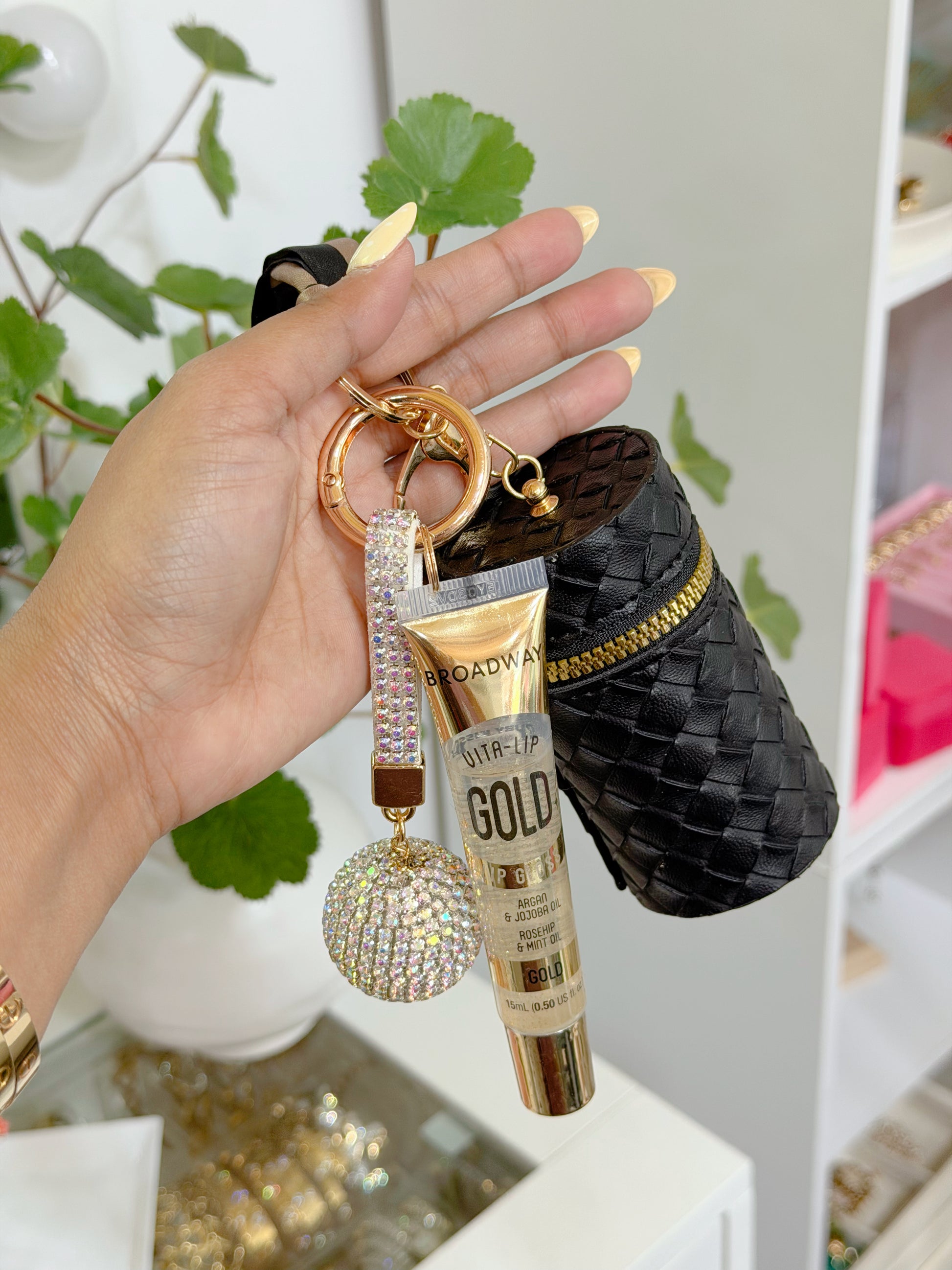 Black woven coin purse combo set featuring a gold zipper, Broadway Vita-Lip Gold lip gloss, and two rhinestone keychains on a gold keyring.