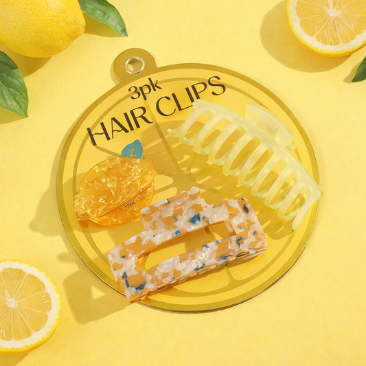 Three-piece lemon hair claw clip set in yellow tones arranged on a citrus-inspired backing card with lemon accents.