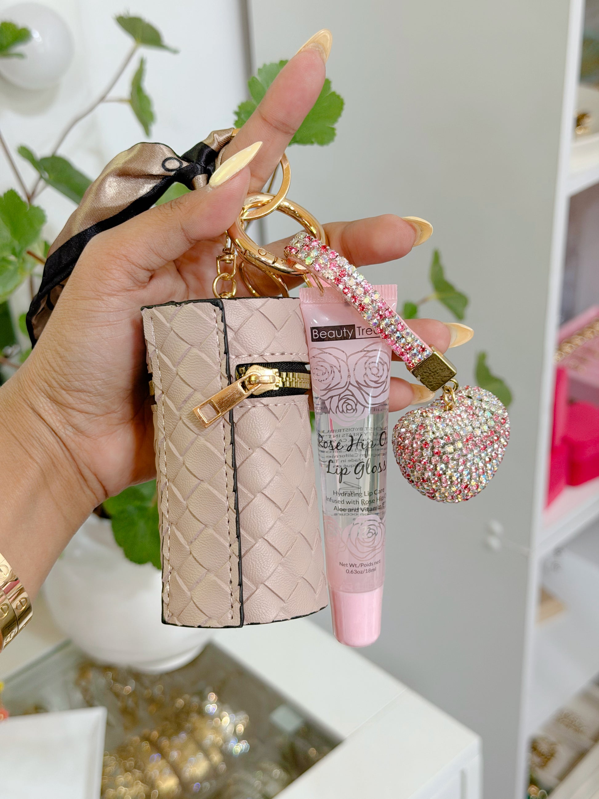 Pale pink woven coin purse combo set featuring a gold keychain, lip gloss, and a sparkly rhinestone heart charm.