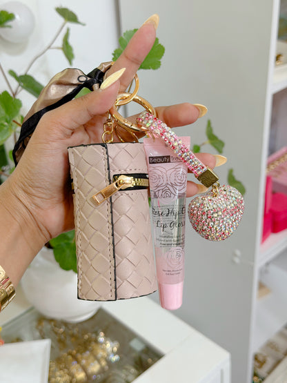 Pale pink woven coin purse combo set featuring a gold keychain, lip gloss, and a sparkly rhinestone heart charm.