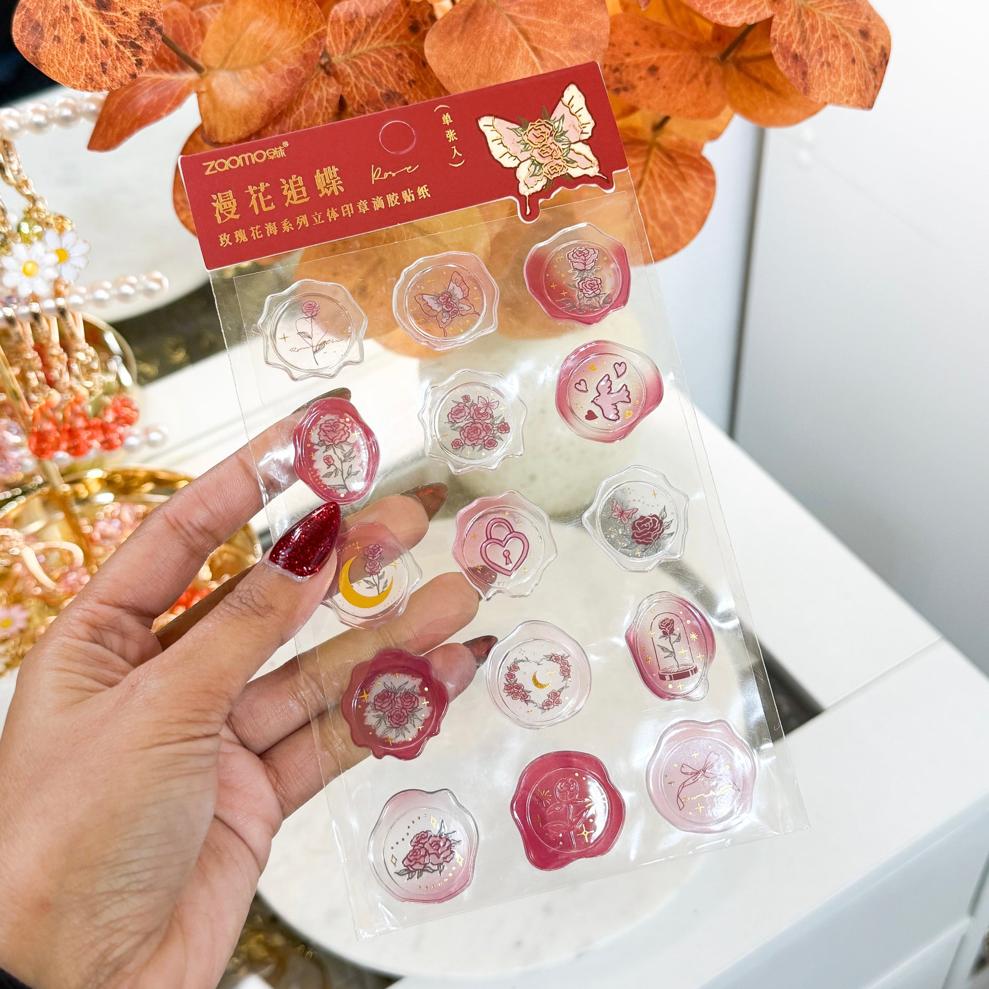 Wax seal stickers by Zoomo, in a clear plastic package, showing rose and butterfly designs.