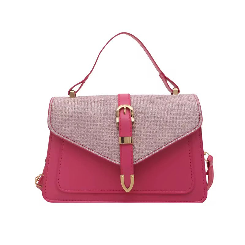 Pink shoulder bag with buckle accent, from an unknown brand, featuring a contrasting textured flap and a top handle.