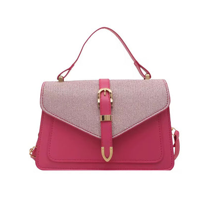 Pink shoulder bag with buckle accent, from an unknown brand, featuring a contrasting textured flap and a top handle.