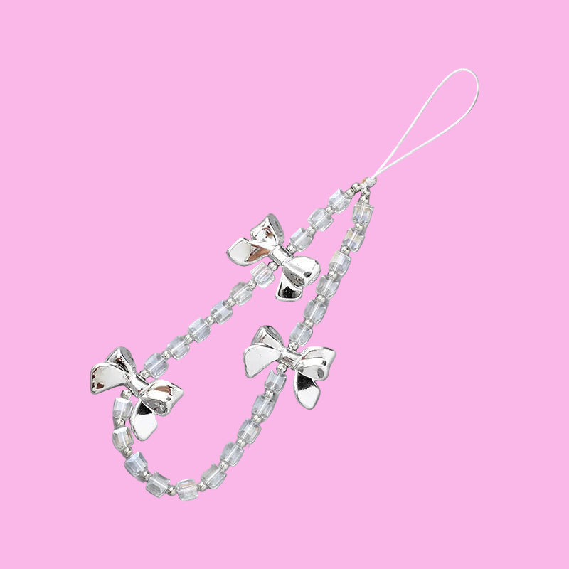 Coquette theme phone charms featuring three silver bows and clear beaded chains with an attachment loop.