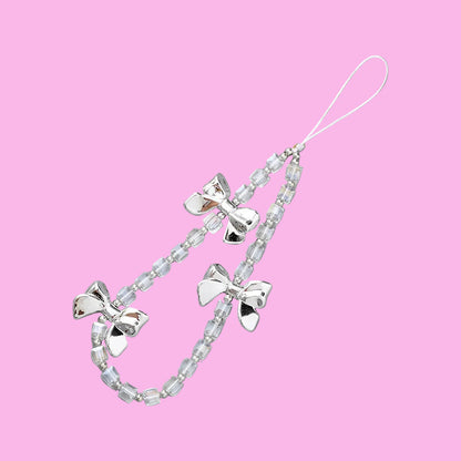 Coquette theme phone charms featuring three silver bows and clear beaded chains with an attachment loop.