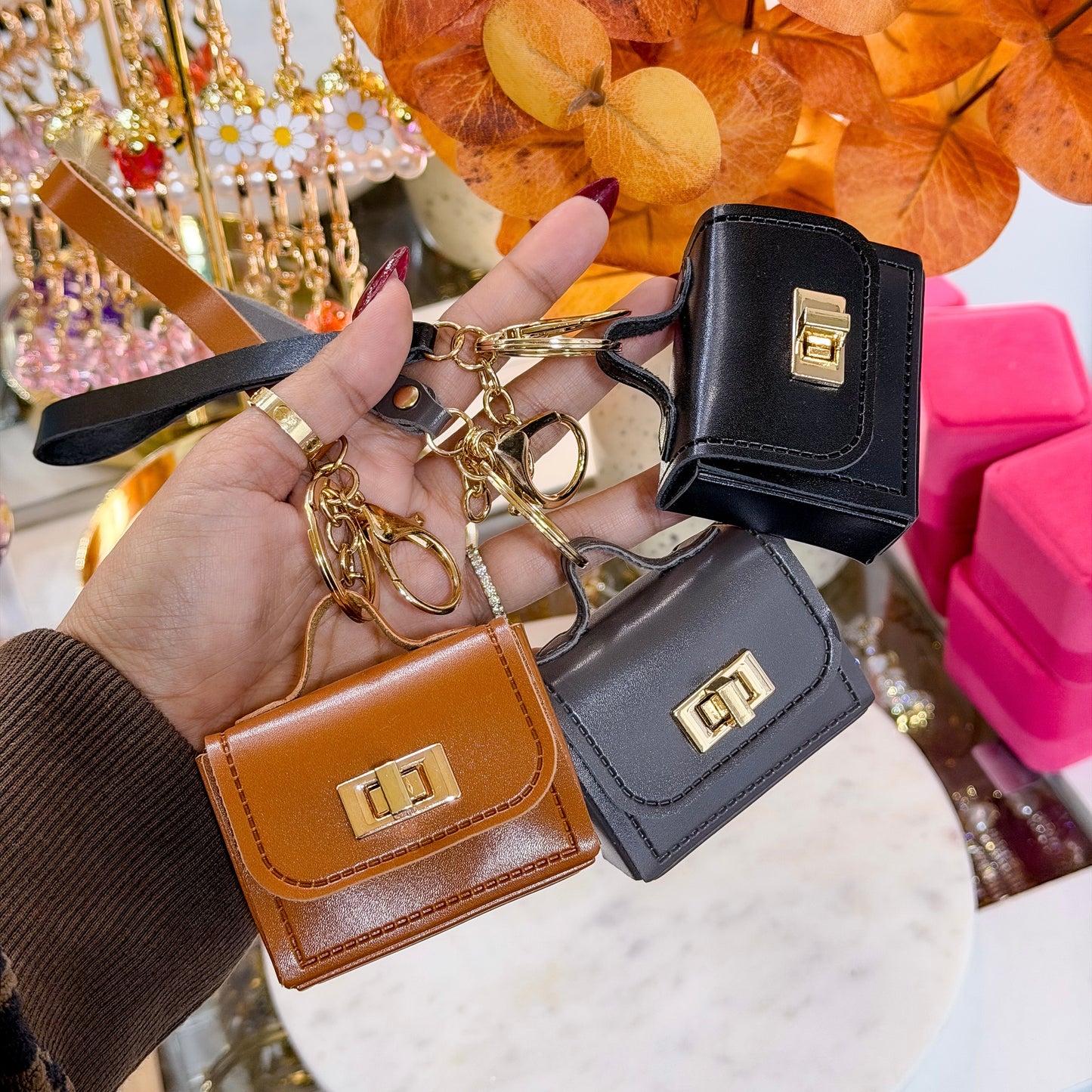 Assorted Mini leather purse bag charm with gold hardware and wrist strap.