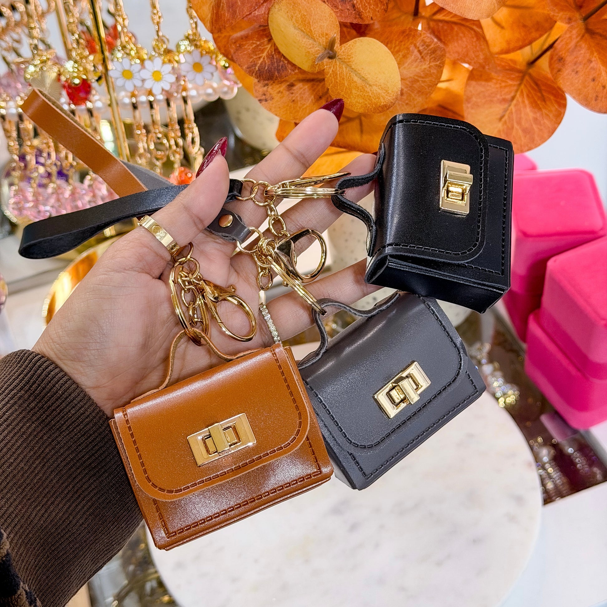 Assorted Mini leather purse bag charm with gold hardware and wrist strap.