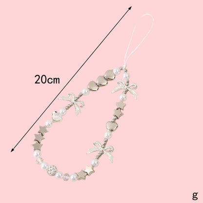 Coquette theme phone charm with white pearls, silver hearts, stars, and bows, measuring 20cm long.