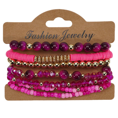 Bohemian style layered bracelets featuring magenta, pink, and gold beads of various shapes, displayed on a brown card.