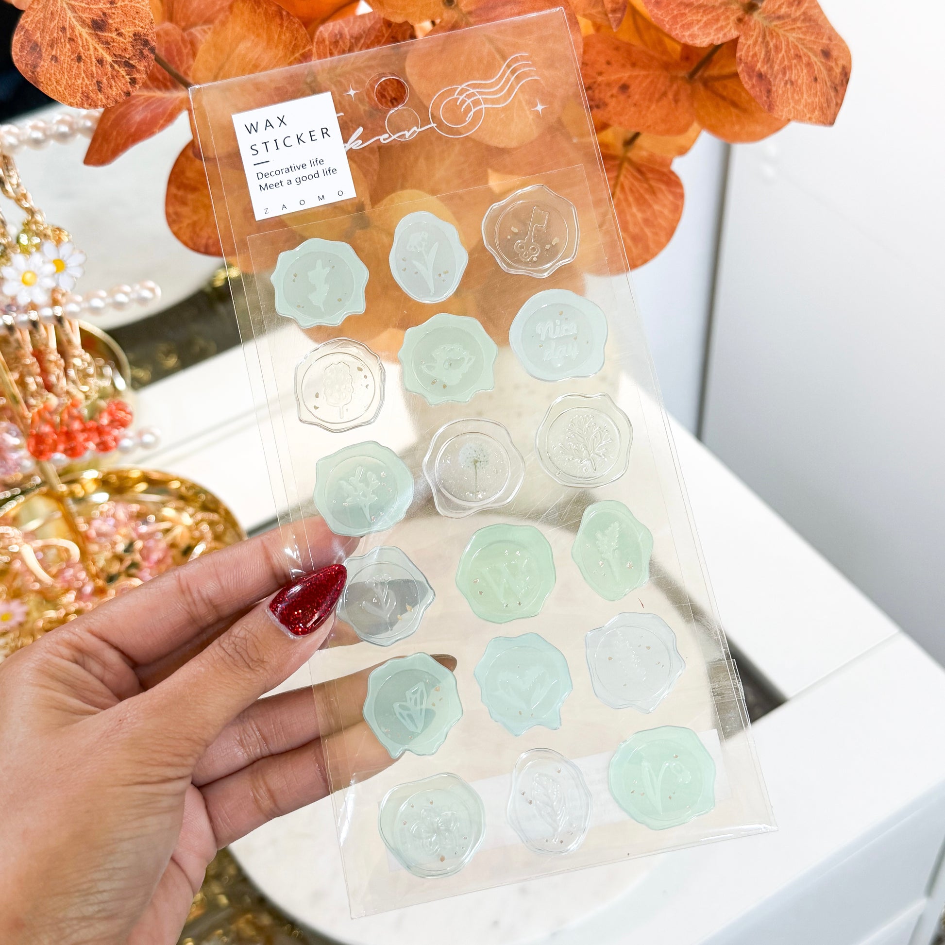 Wax seal stickers by ZAOMO, featuring delicate floral and botanical designs in muted green and clear shades.