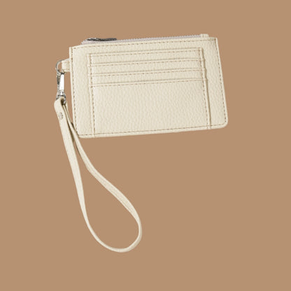 Ivory slim wristlet card holder with clear ID pocket from an unknown brand, featuring a grainy texture and a silver zipper.