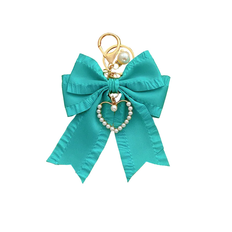 Teal fabric Pearl Bow Bag Charm with a gold-tone clasp, featuring a hanging pearl heart charm and a single pearl.
