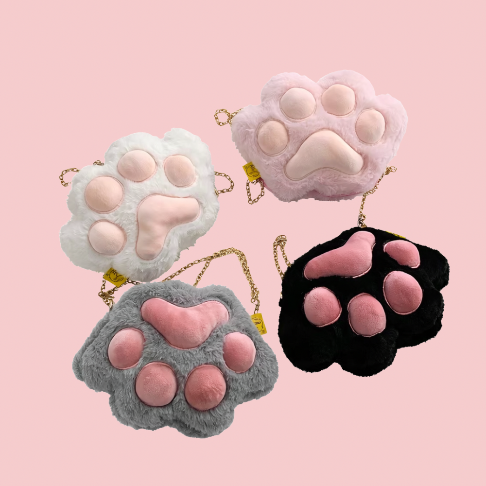 Four plush paw-shaped bags in different colors on a pink background