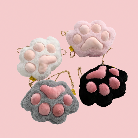 Four plush paw-shaped bags in different colors on a pink background