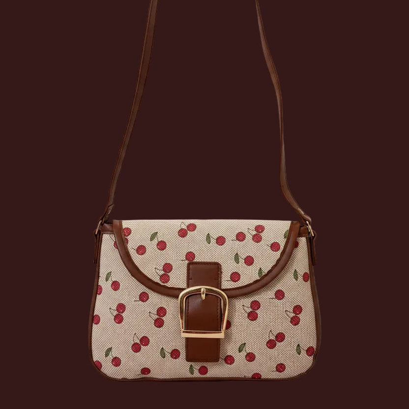 Small cherry print, black trim and strap, and gold buckle closure; available in black and red. 