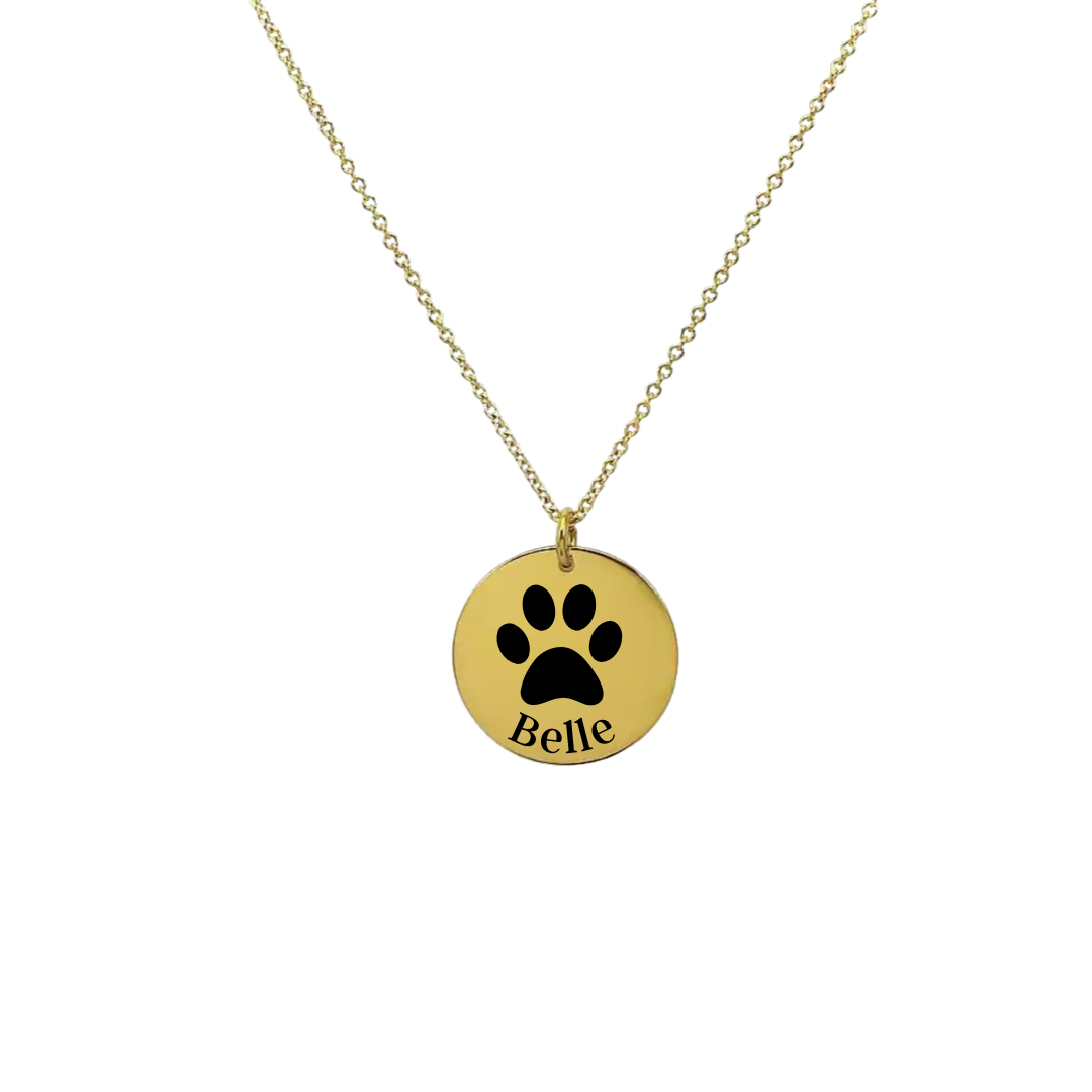 Gold necklace with custom paw print pendant with name detail.